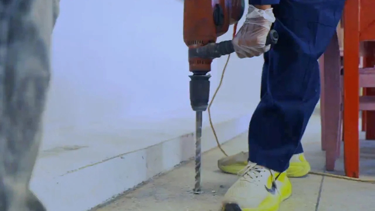 Nest Fumigation technician drilling the foundation line for termite proofing in Karachi